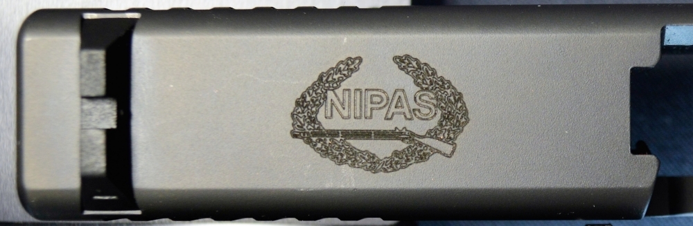 Ace Laser Tek laser engraving of NIPAS Logo on 9mm Glock Pistol2